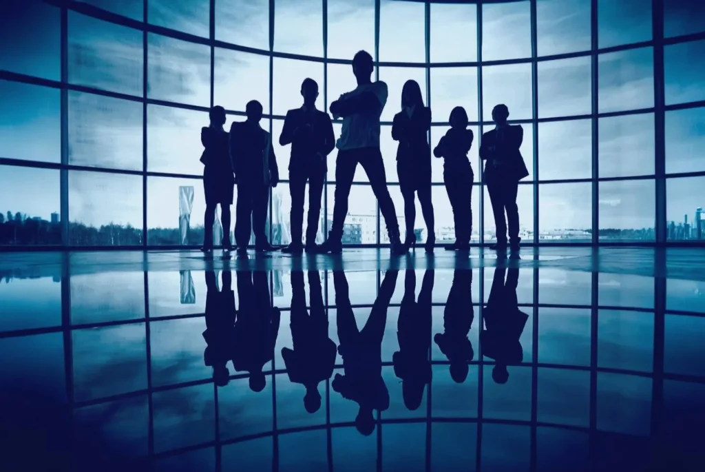 A group of people standing in the shadows, creating a professional and mysterious atmosphere, representing teamwork and expertise in SEO growth.